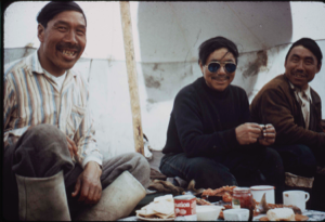 Image of Three Eskimo [Inuit] men in a tent, eating