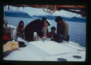 Image: MacMillan and Inuit looking at a chart