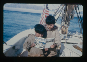 Image of Two Eskimo [Inuit] boys aboard look at "Etuk, The Eskimo [Inuit] Hunter"