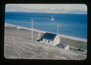 Image of Building at Pond Inlet with British flag. The Bowdoin moored  (2 copies)