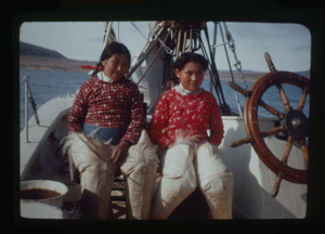 Image of Eskimo [Inuit] mother and daughter by wheel (2 copies)