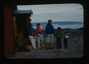Image of Eskimo [Inuit] family outside frame house