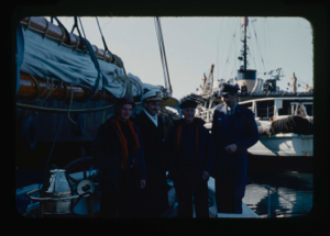 Image of Donald and Miriam MacMillan with two officers of ice breaker. On the Bowdoin