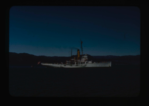 Image: The Bowdoin beside a ship.