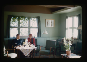Image of Miriam MacMillan having coffee in Danish official's home (2 copies)