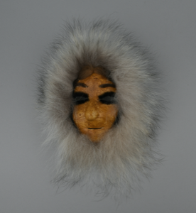 Image of caribou skin mask, female wearing white fur ruff 