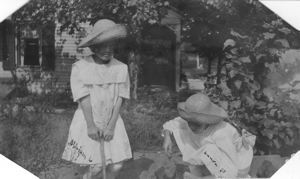 Image: Miriam, age 6, and Laura (age 10) Look in straw hats