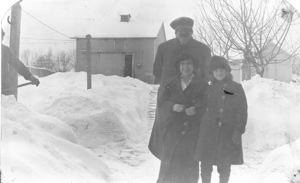 Image: Couple and Miriam Look in snowy yard