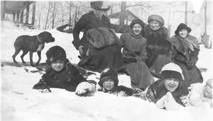 Image: 4 children and 4 women, with dog, in snow. Includes Miriam, Laura, Amy Look