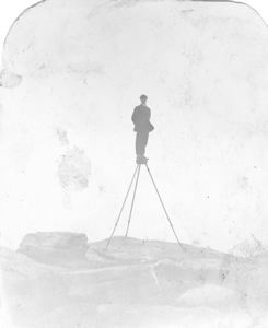 Image: Donald MacMillan standing on tall tripod
