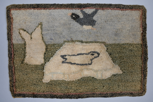 Image: Hooked Mat, motif of seal on ice floe with duck flying overhead