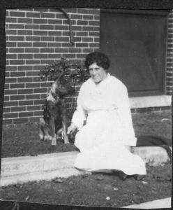 Image of Miss Burns with the 6 month old police puppy.