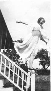 Image of Laura, spread eagle jumping off porch steps. "Humph, who couldn't do that" sa