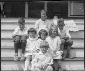 Image of Seven children sitting on steps