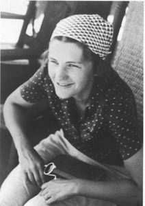 Image of Miriam MacMillan wearing kerchief, on porch