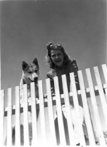 Image of Laura Look and dog by fence