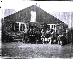Image of Group by frame/rock/sod house