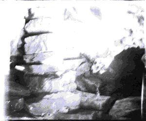 Image of Rock/sod entrance, detail. Note harpoon