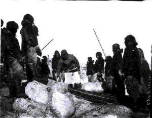 Image of Group of Inuit men and boys with supplies and tools