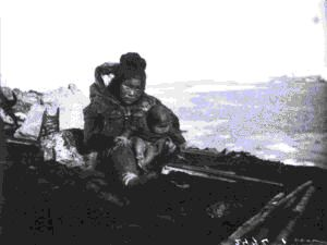 Image of Inuit mother and baby sitting