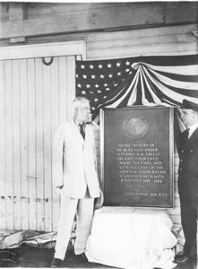Image: Adolphus Greely and Donald MacMillan standing by Greely tablet readied for trans