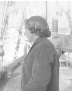 Image of Thomas McCue, hatless, in profile on deck