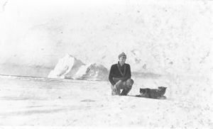 Image of Donald Mix and two dogs near iceberg