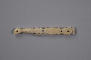 Image of small ivory folding knife with carved arm and fist motif 