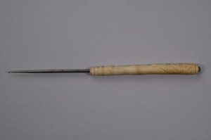 Image: ivory crochet hook with flat top carved into a fish's head