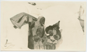 Image of Two Inuit women pouring Hay's Lime and Lemon on Bowdoin