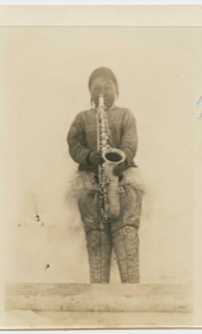 Image: Inuit woman playing a saxophone