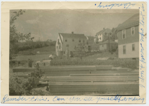 Image of Rear of houses; lumber in foreground