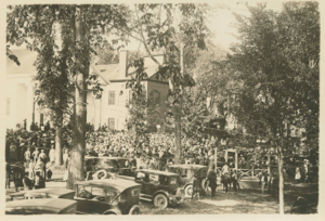 Image of Crowd gathered outside church and courthouse for Departure activities.Note horse
