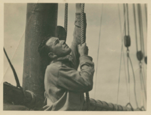 Image: Crew man hoisting sails
