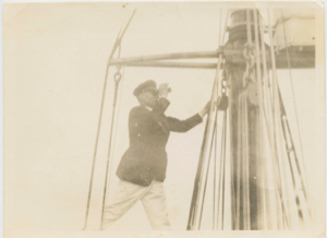 Image: Donald MacMillan ? in rigging with binoculars