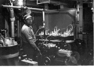 Image of Crewman with equipment (in boiler room?)