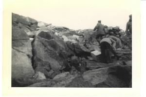 Image of Group on rocks, with boxes