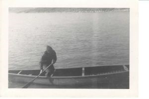 Image of Man standing in canoe - paddling