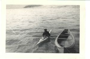 Image: Greenlander in kayak beside canoe