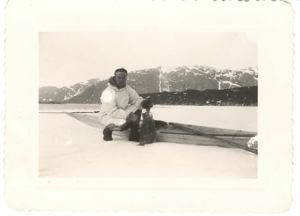 Image of Sgt. Parker with fish, by kayak on snow