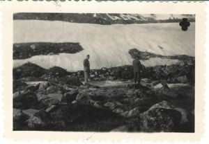 Image: Two servicemen at foot of glacier
