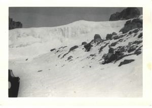 Image of Serviceman with gear, sitting on snow