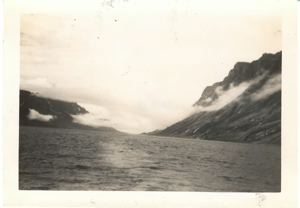 Image of Clouds low over mountains, and water