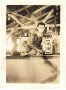 Image of Serviceman under rafters, with equipment