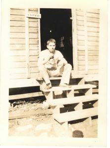 Image: Sericeman with bottled drink, sitting on steps