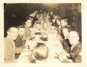 Image: Quartermaster Christmas dinner. Left foreground: Sgt. Nelson; right foreground L