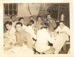 Image of Company cooks at dinner, by Christmas tree