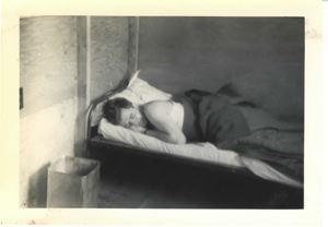 Image: Serviceman sleeping on cot