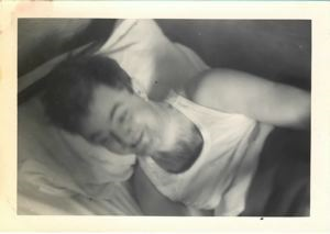 Image of Serviceman lying on cot