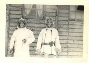 Image of Two servicemen in fur-trimmed parkas, outside officers' barracks